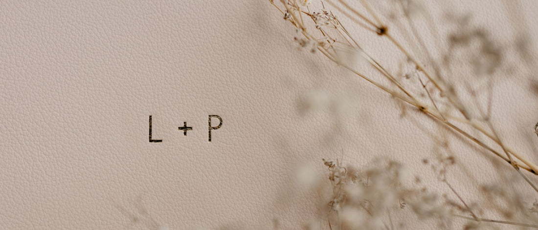 lush pink spring leather wedding album with gold foiled initials of the bride and groom that read "L + P'