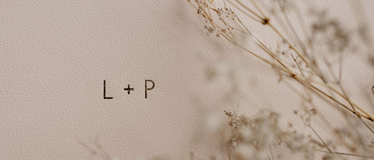 lush pink spring leather wedding album with gold foiled initials of the bride and groom that read "L + P'